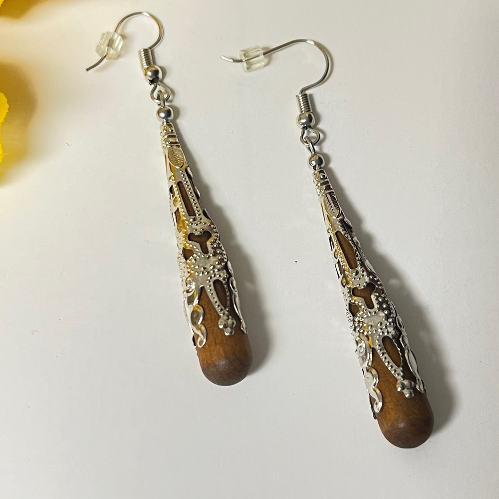 Earrings, Rich, wooden drop  wrapped in silvery filigree  cover. New. Length 2”
